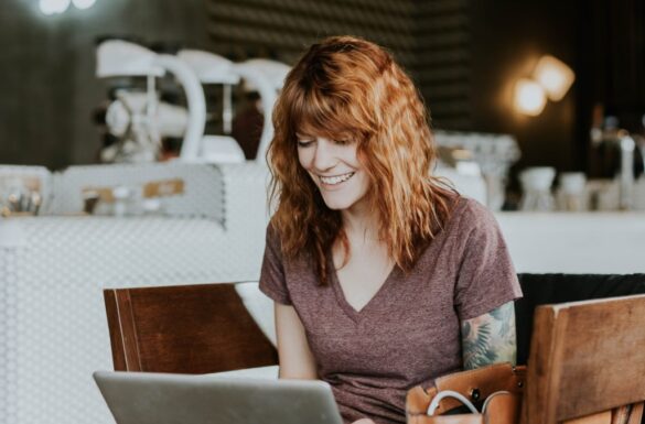 Mujer sentada trabajando en un café, mientras hace study and work en Australia